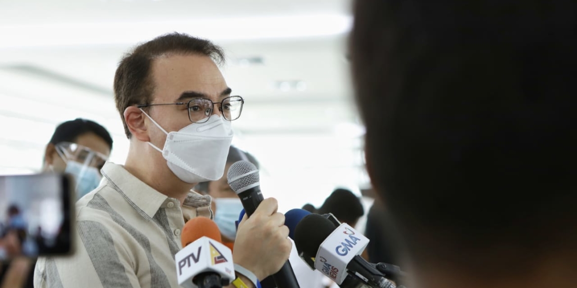 Former House Speaker Alan Peter Cayetano speaks with the media during the rollout of vaccines and distribution of cash aid for seafarers on June 25, 2021.