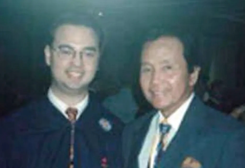 A vintage photo shows Alan Peter Cayetano in academic attire alongside with Rene Cayetano, possibly at a graduation or formal event.