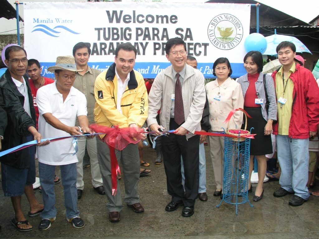 Alan Peter Cayetano cuts a ribbon at a "Tubig Para sa Barangay Project" event, signifying water access improvements.