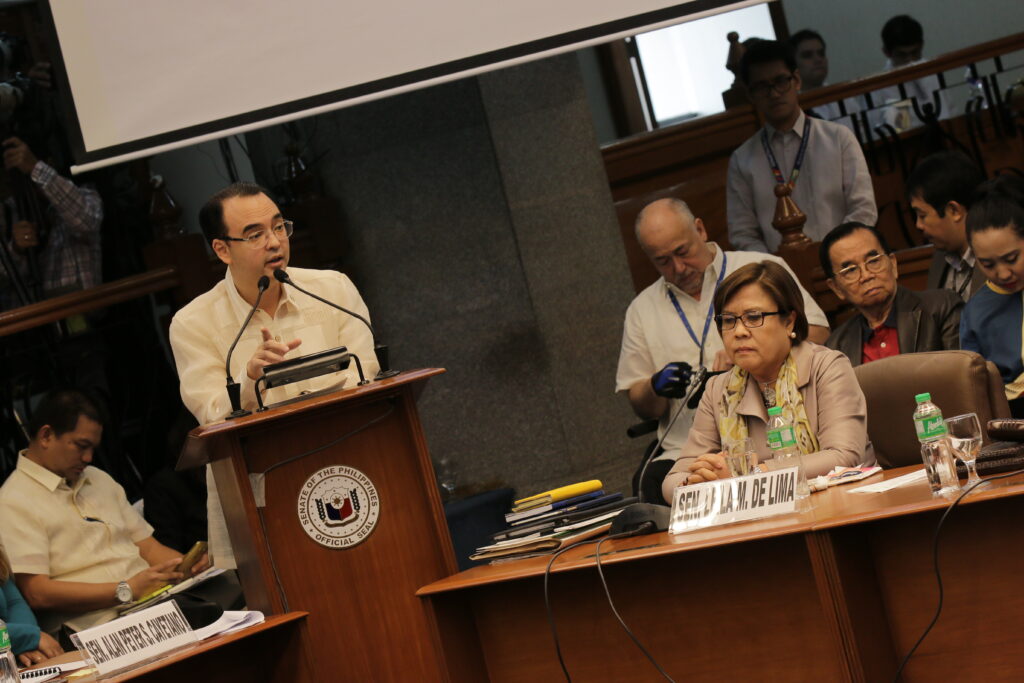 Cayetano delivers a speech at the Senate, with De Lima present, advocating for policies, leading discussions, and shaping legislative agenda.