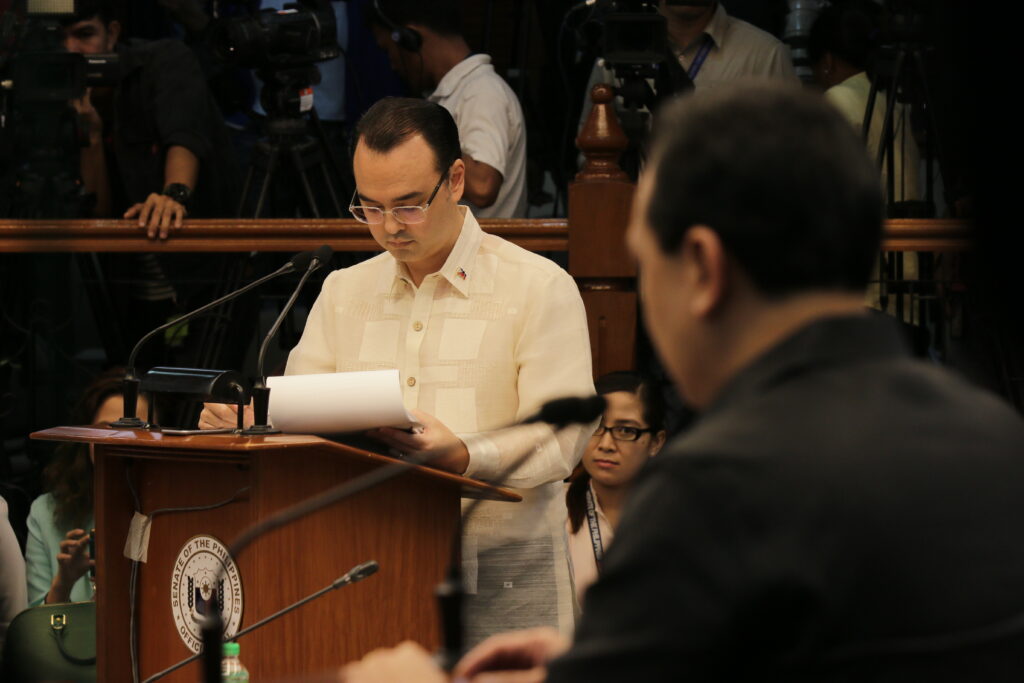 Cayetano reads a statement at the Senate, focusing on policy details, presenting arguments, and engaging in legislative proceedings.