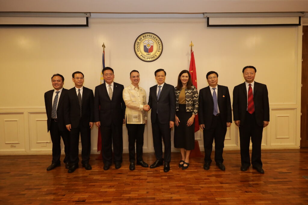 Cayetano shakes hands with a Chinese official, fostering diplomatic ties at the House of Representatives, promoting international relations.