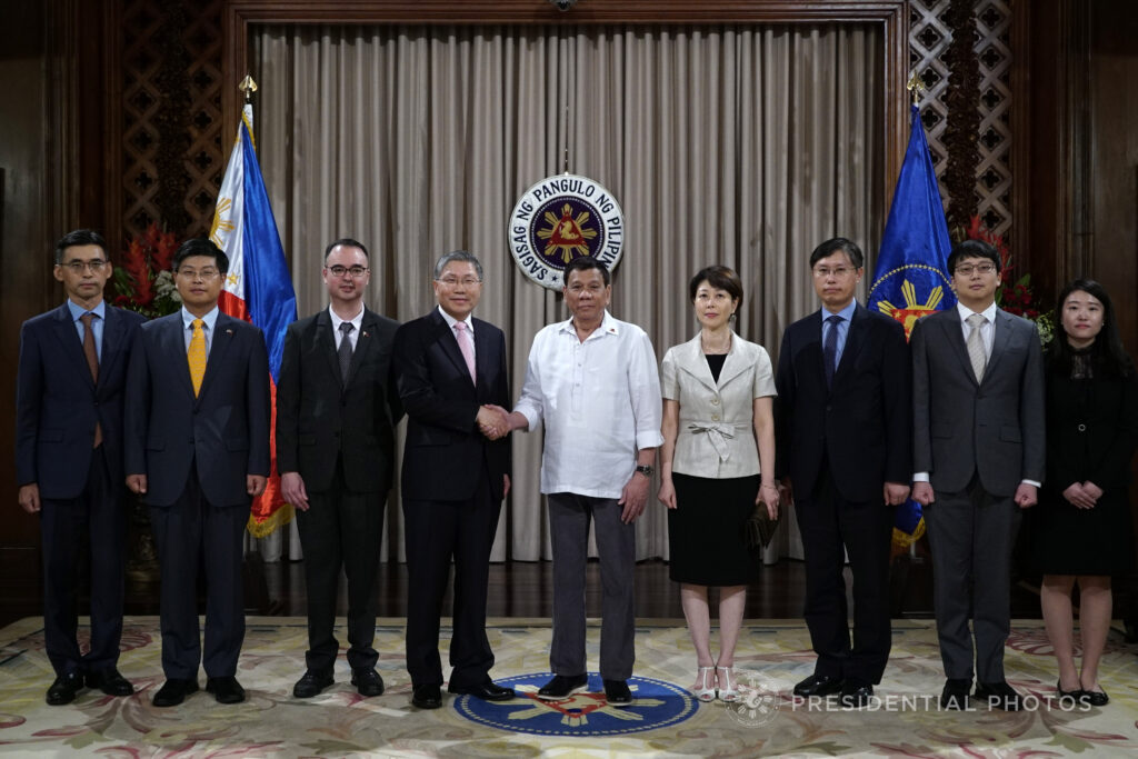 Alan Peter Cayetano stands alongside Duterte and foreign dignitaries, symbolizing diplomatic relations and official state visits.