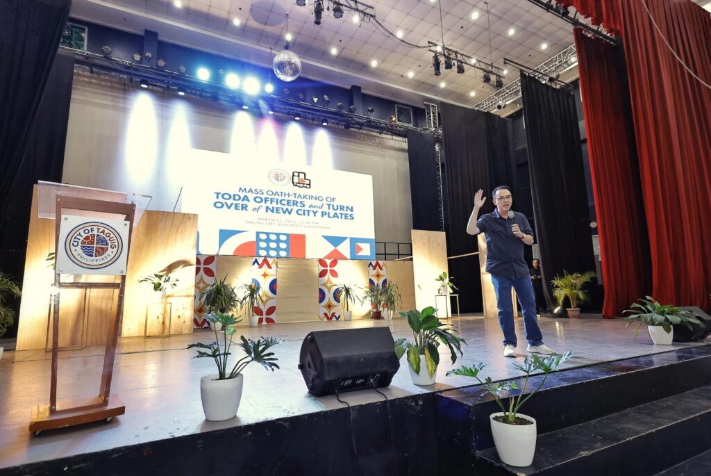 Alan Peter Cayetano speaks at a TODA officers' event in Taguig, addressing the audience, promoting city initiatives, and engaging with the community.