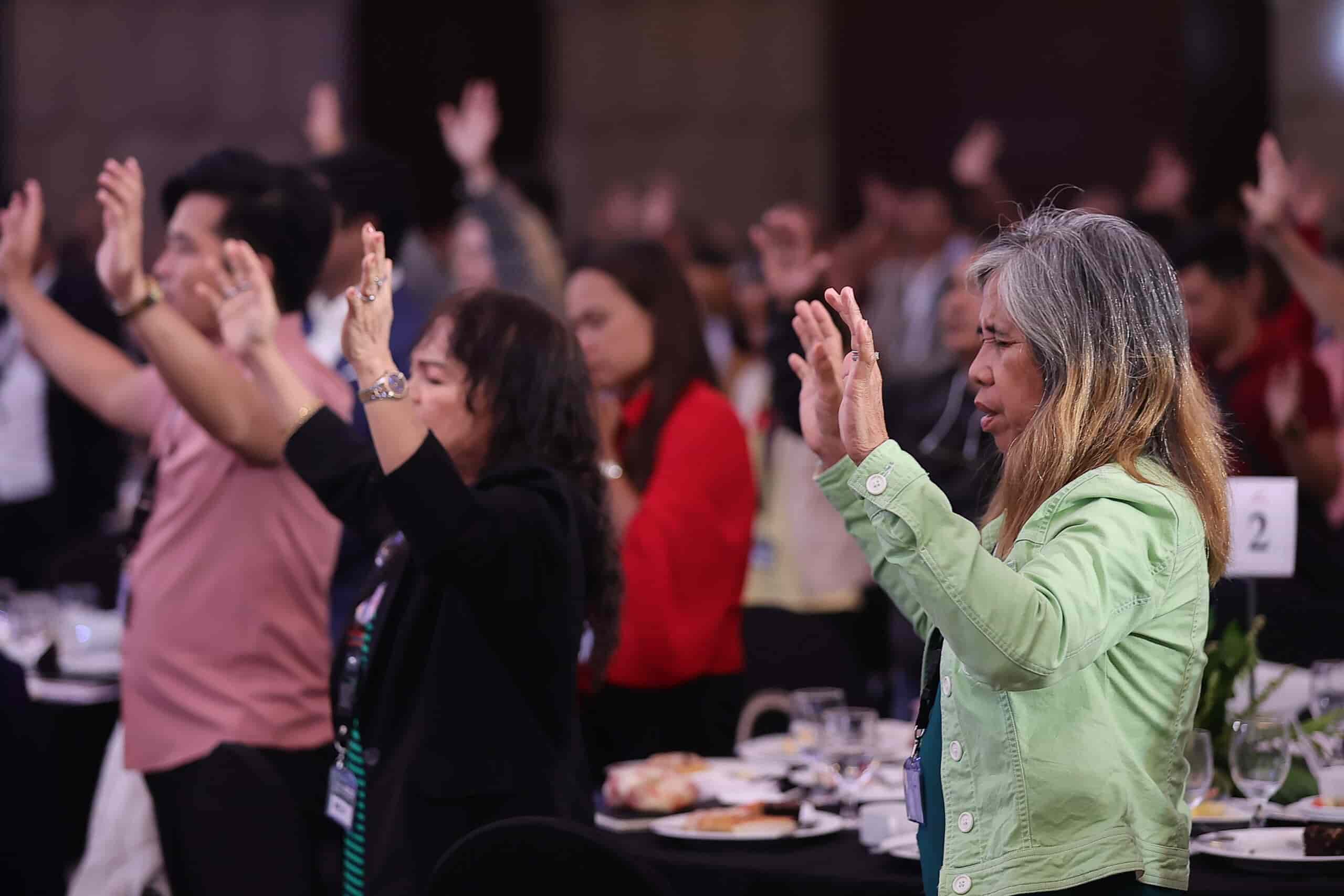 Audience engaged in praise and worship during the Transformnation gathering