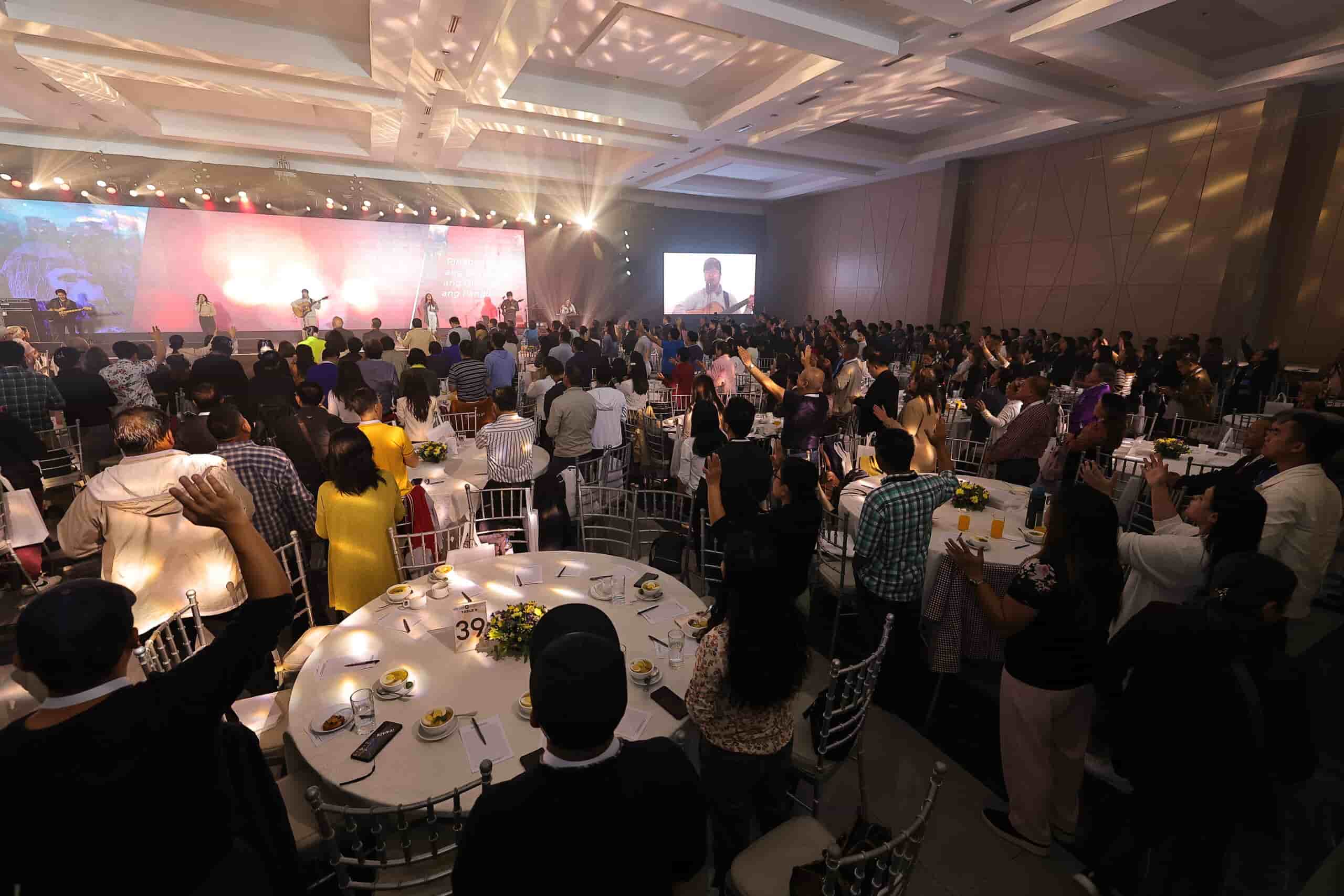 Attendees participating in praise and worship at the Transformnation event